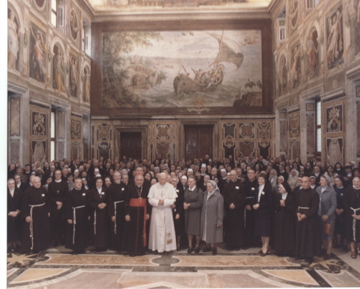 large group of franciscans gathered with Pope John Paul II celebrating the new Third Order Regular Rule.