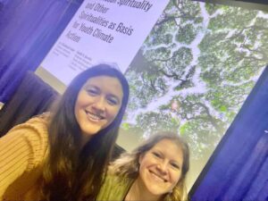 smiling young women in front of a presentation