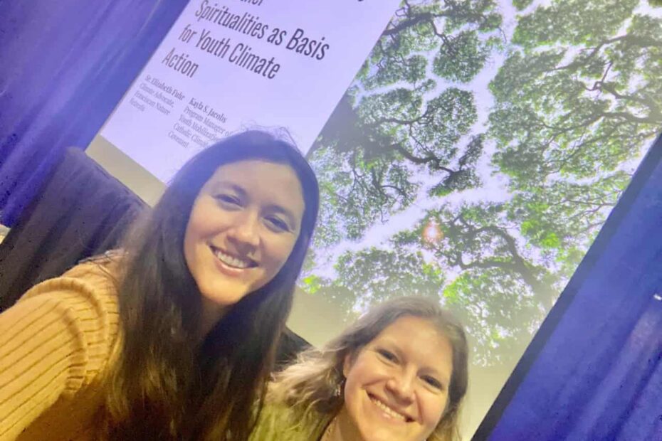 smiling young women in front of a presentation